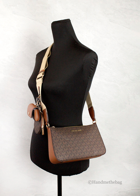 Brown monogram crossbody bag with adjustable strap and small hanging charm pouch