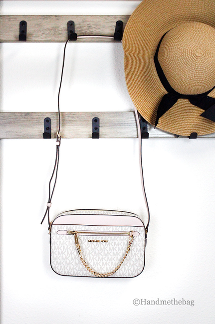 Michael Kors crossbody bag with MK monogram front, chain strap, and zip closure