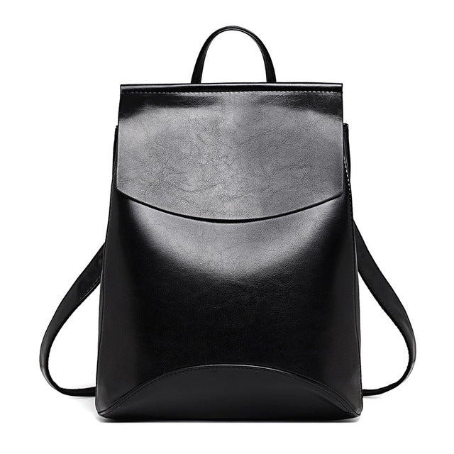 Black leather backpack with curved front flap and adjustable shoulder straps