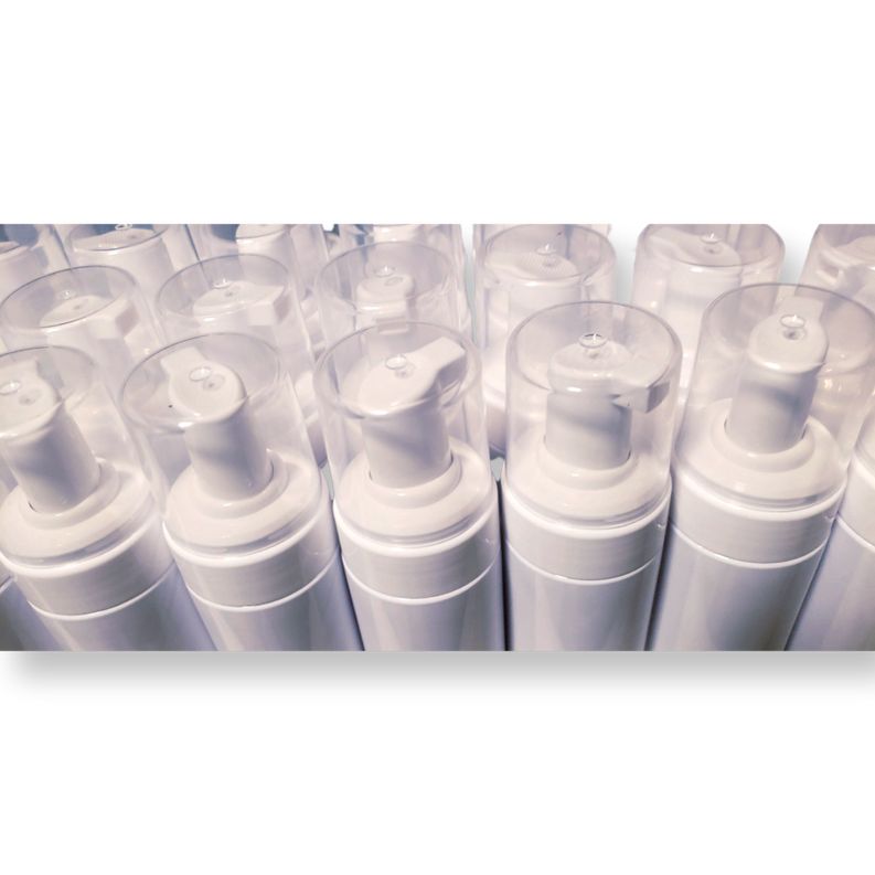 Foaming wash bottles with white caps, arranged in a clear plastic tray
