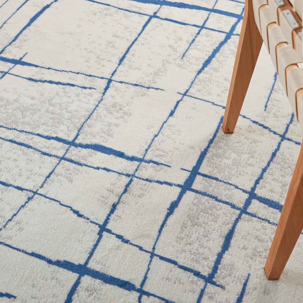 5' X 7' Blue And Ivory Abstract Dhurrie Area Rug