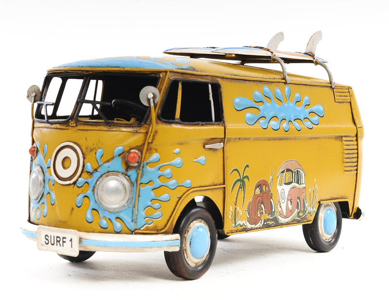 Yellow metal model van side view with blue wave art and cartoon mural near front.