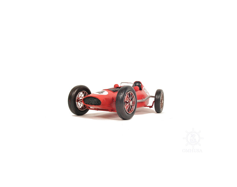 Red metal model car tabletop sculpture with open cockpit details, front 3/4 view