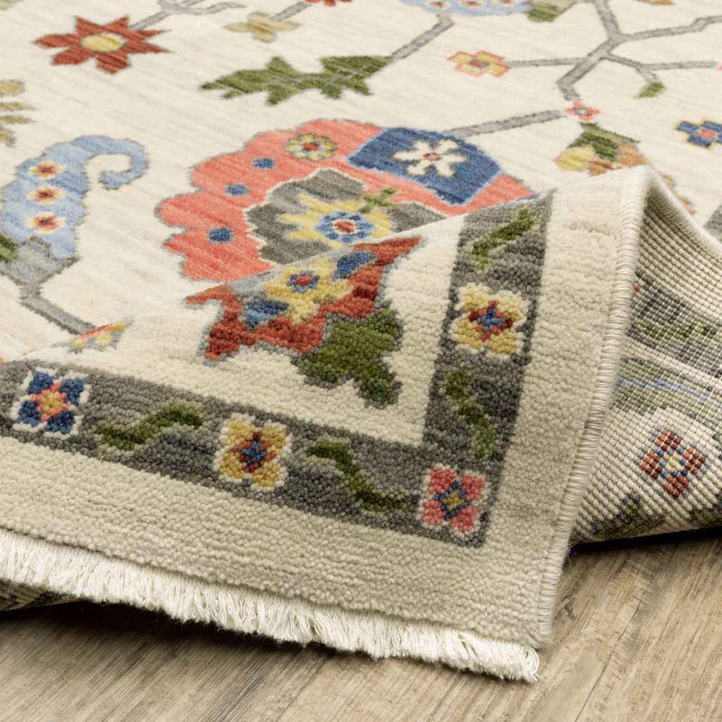 10' X 13' Ivory Green Blues Pink Yellow Rust Brown Tan And Grey Oriental Power Loom Stain Resistant Area Rug With Fringe