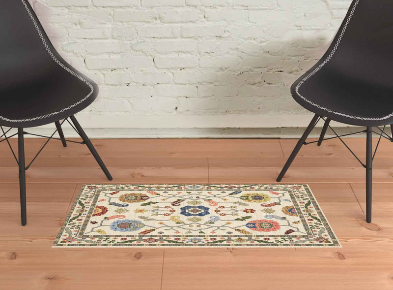 2' X 3' Ivory Green Blues Pink Yellow Rust Brown Tan And Grey Oriental Power Loom Stain Resistant Area Rug With Fringe