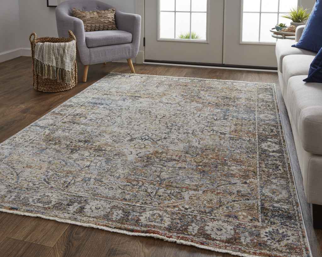 10' X 13' Tan Orange And Blue Floral Power Loom Distressed Area Rug With Fringe