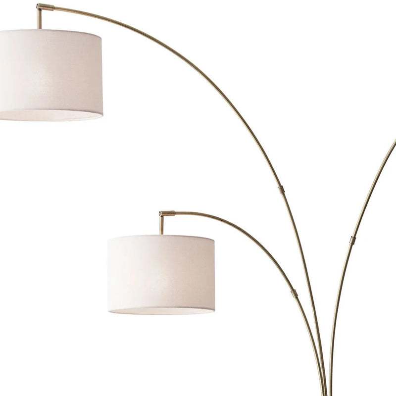 74" Brass Three Light Arc Floor Lamp With Off White Fabric Drum Shade - Lighting