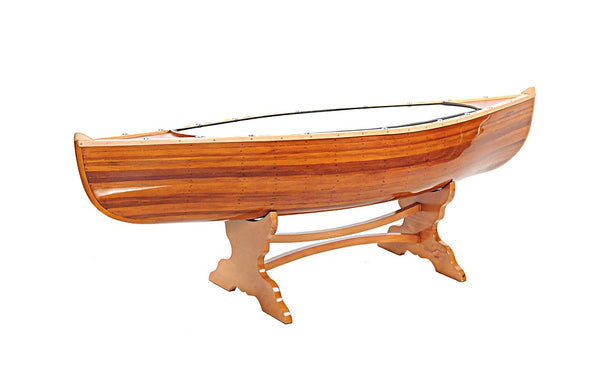 Canoe-shaped wood coffee table with glass top and trestle-style legs