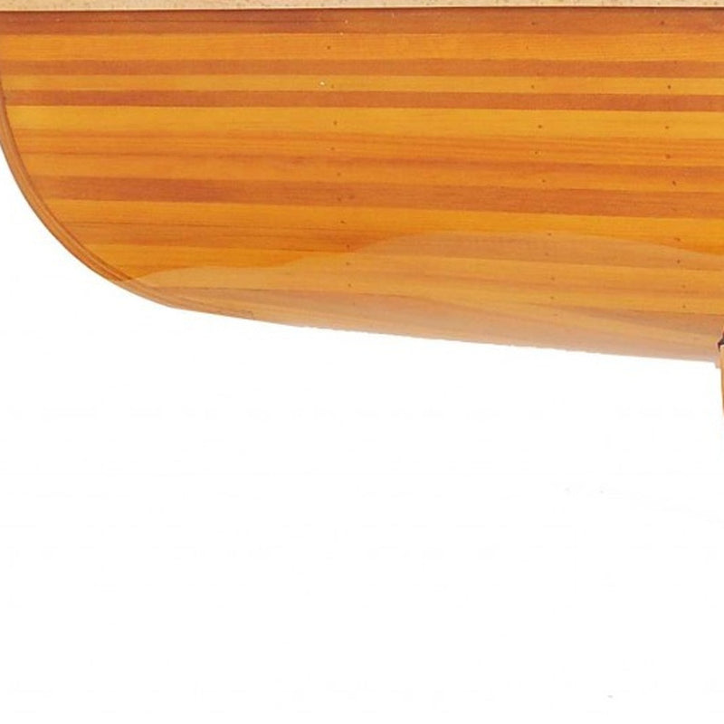 Curved wooden tabletop edge detail on a canoe-shaped coffee table