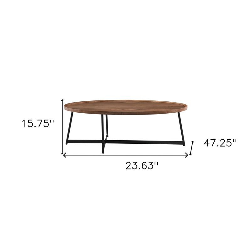 Oval coffee table with brown wood top and black metal frame, 47.25 in long