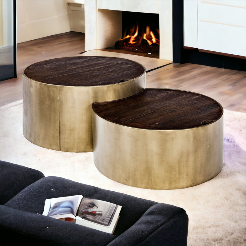 Two round nesting coffee tables with dark wood tops and gold-toned metal frames