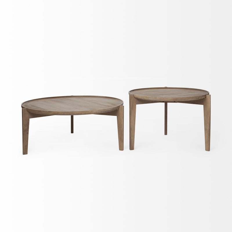 Pair of round nested coffee tables with light brown wood tops and tapered legs
