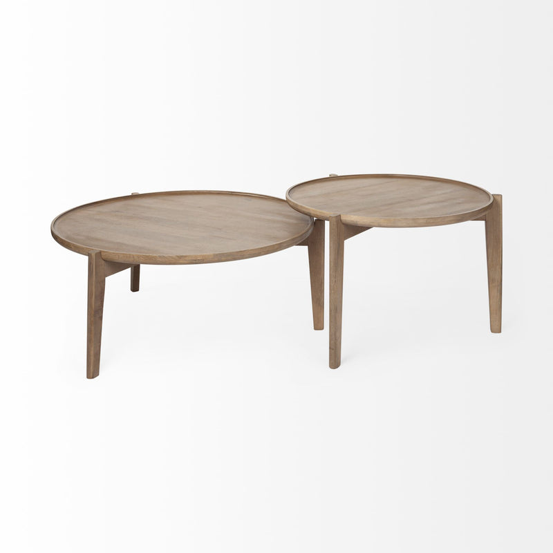 Two round nested coffee tables with light wood tops, curved edges, tapered legs