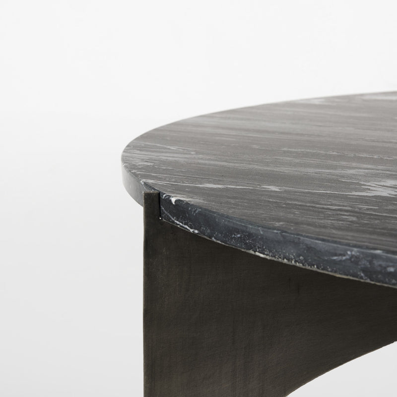 Black round marble coffee table corner with dark iron side leg