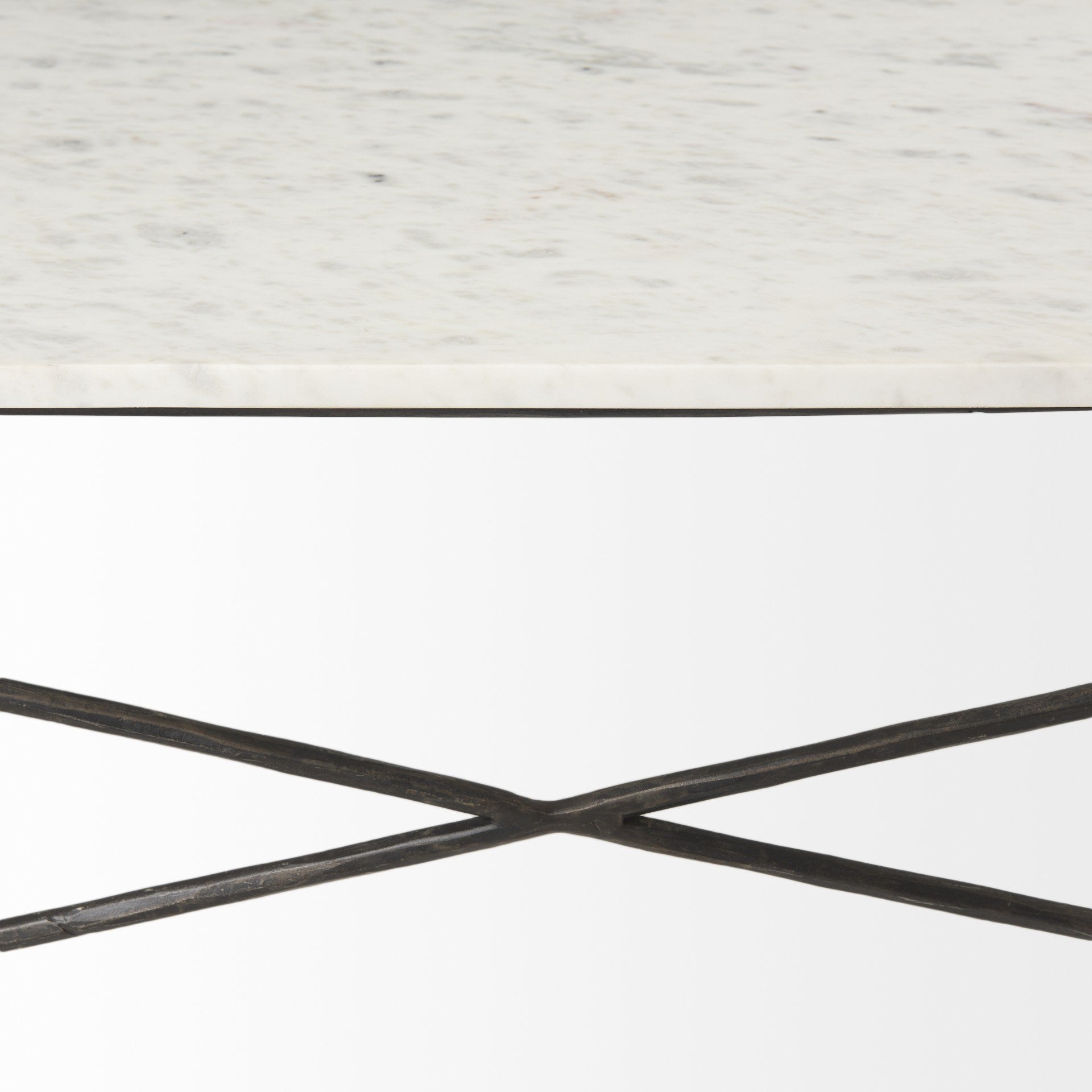 Underside view of white marble top with black metal cross supports