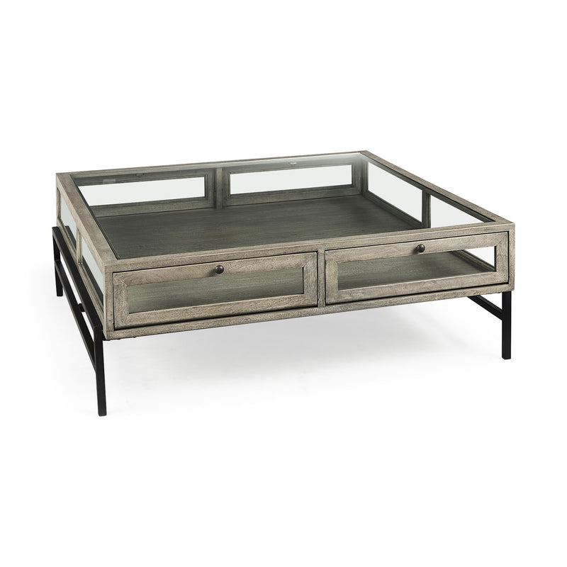 Square coffee table with gray wood-look drawers, glass inset tabletop, black metal legs