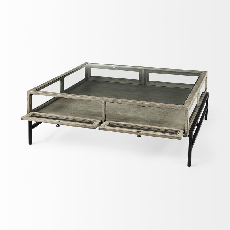 Square coffee table with glass top and two drawers, gray wood-look finish, black supports