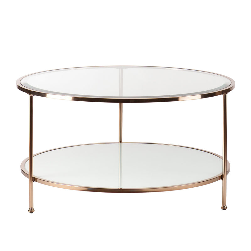 Round clear glass coffee table with gold iron frame and two circular glass shelves