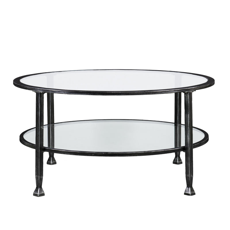 Round black metal coffee table with two clear glass shelves, front view
