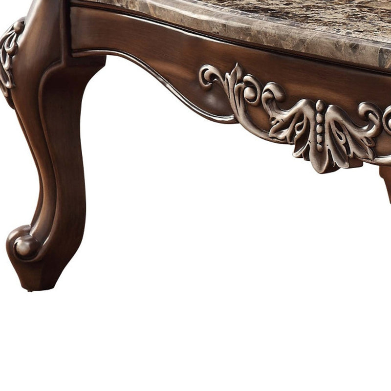 Brown coffee table base with ornate carved scrollwork and curved legs
