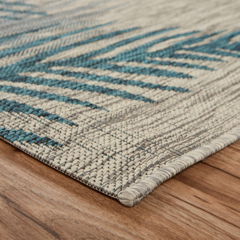 Textured area rug weave with teal blue stripe bands on a light gray background.
