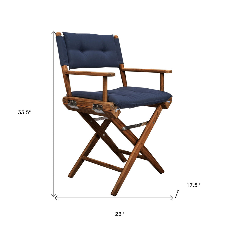 Navy-cushioned wood director chair with padded backrest and armrests, folding frame