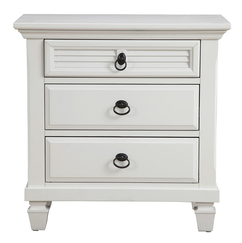 White wood 3-drawer nightstand front view with black ring pulls and carved top