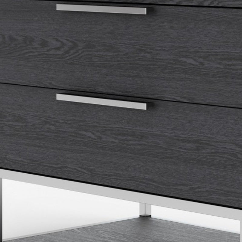 Gray nightstand drawer fronts with silver bar handles and visible wood grain.
