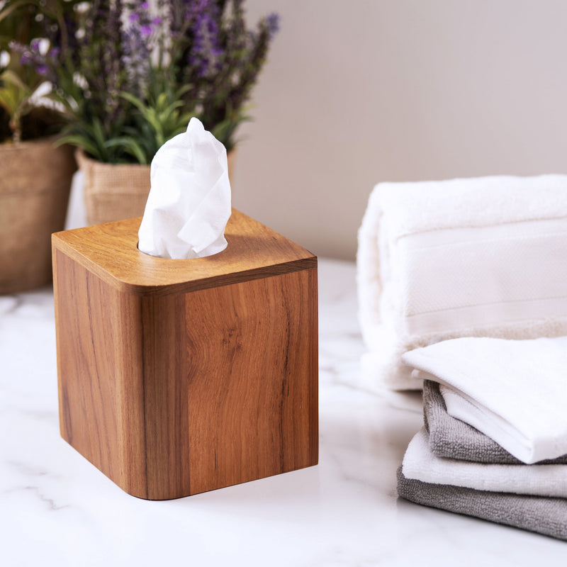 Wooden teak tissue box cover with round opening on top, set on countertop