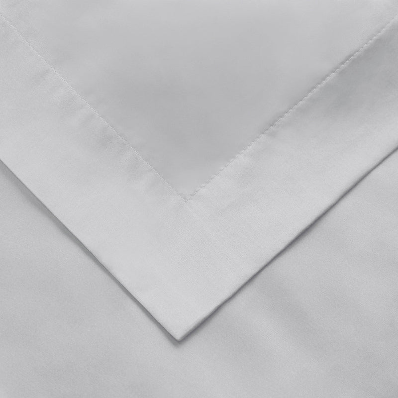 Light gray cotton duvet cover corner with neat stitched seam