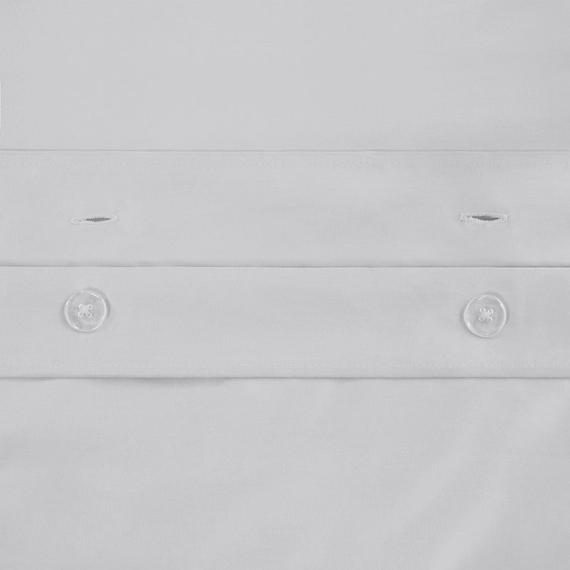 White cotton duvet cover button closure detail with round plastic buttons
