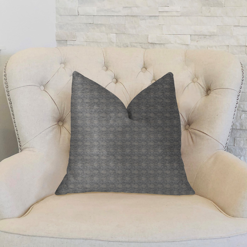 Blue-gray decorative throw pillow with small circular halo motif, tailored edges.