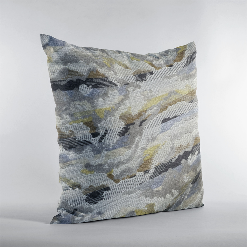 Decorative pillow standing photo with gray and blue camo-like pattern and yellow highlights