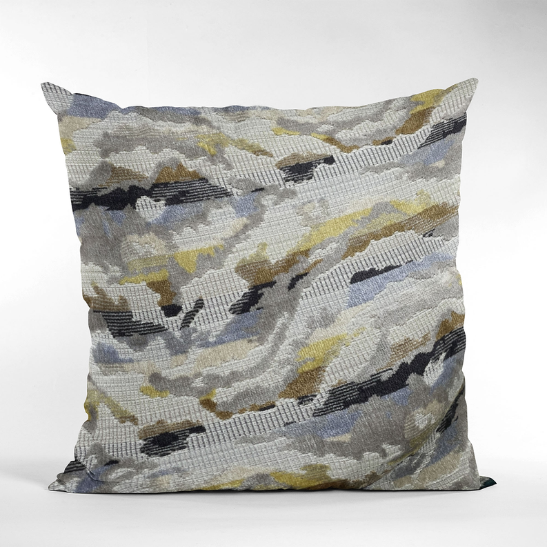 Decorative throw pillow with abstract camo pattern in gray, blue, yellow, and black