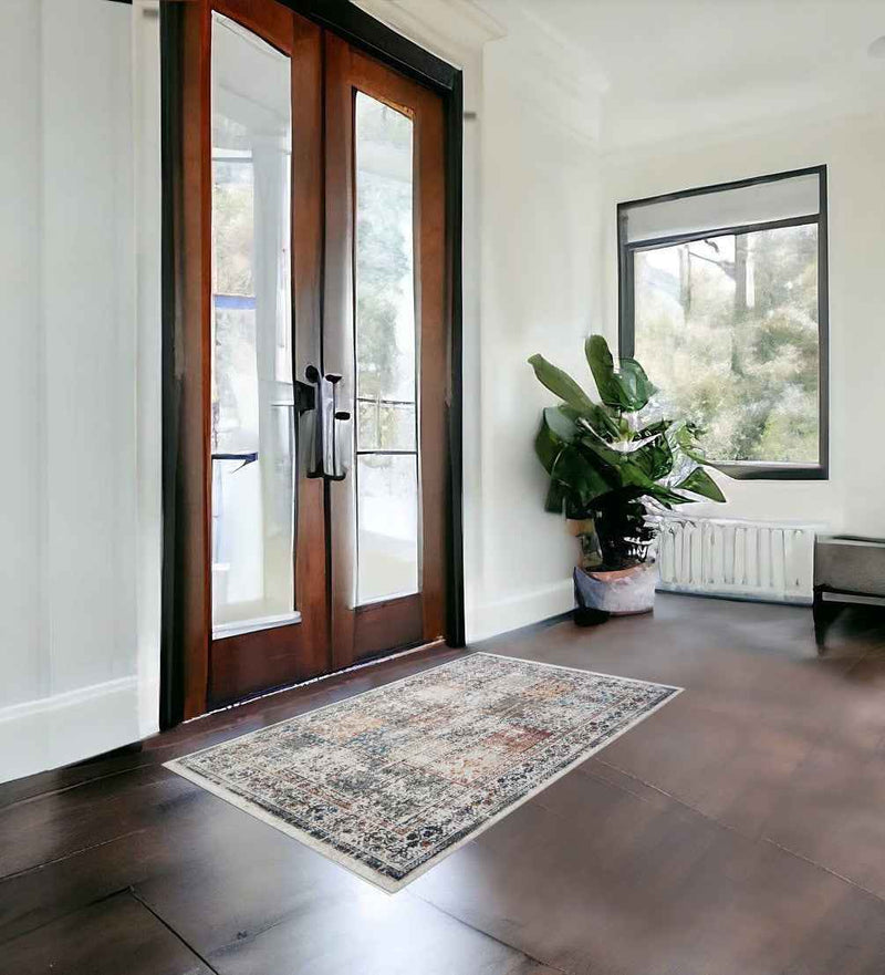 2' x 3' Ivory Blue and Gray Patchwork Distressed Area Rug With Fringe