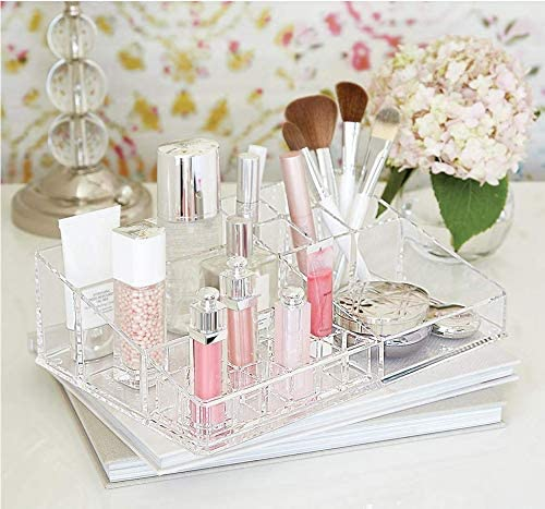 Clear acrylic organizer tray with lipstick compartments and makeup items on tabletop