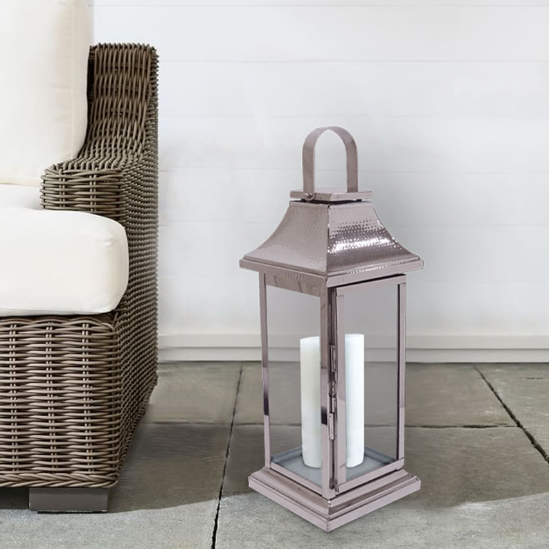 Silver metal candle lantern with glass panels, arched handle, and flared top