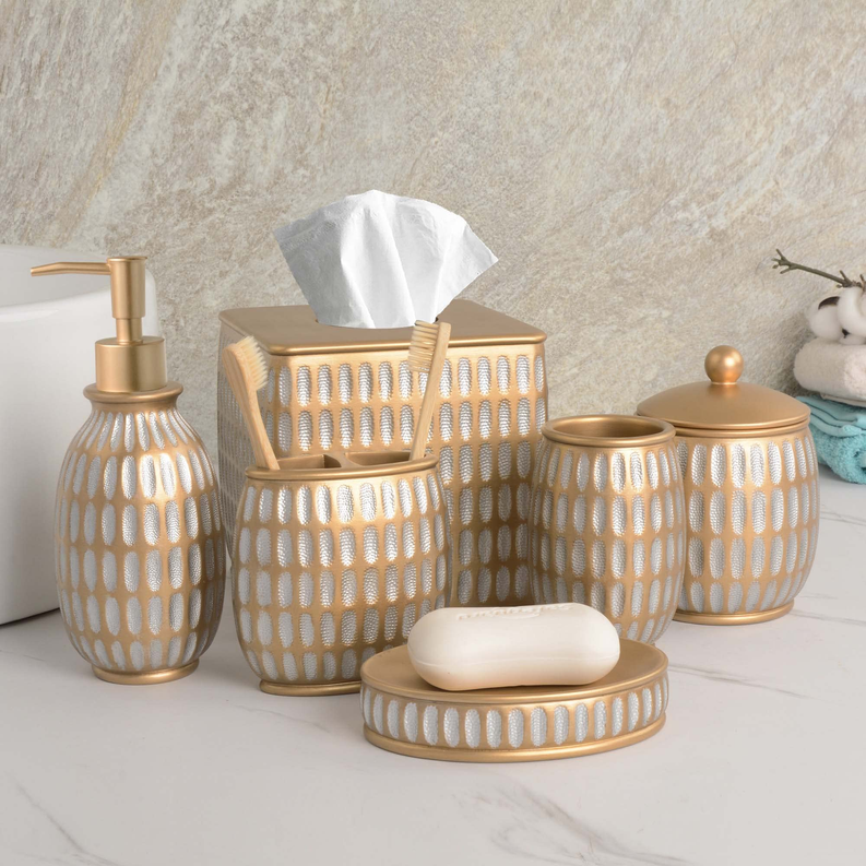 Bathroom accessory set of beige ceramic with gold accents, includes tissue box, soap dish, and cups