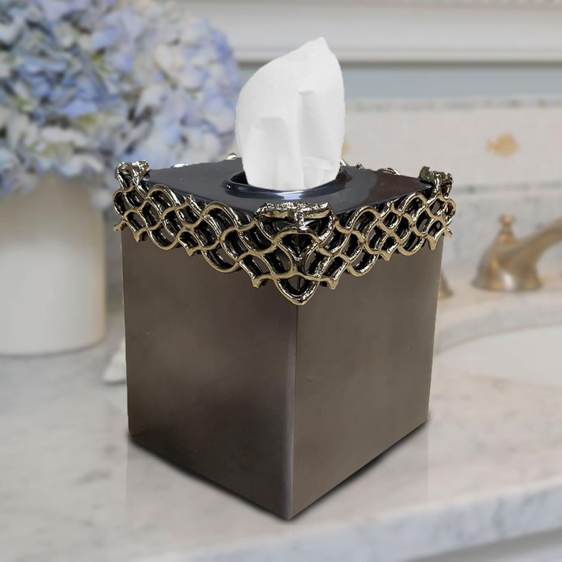 Tissue box cover, dark square box with ornate gold chain-style trim and white tissue.