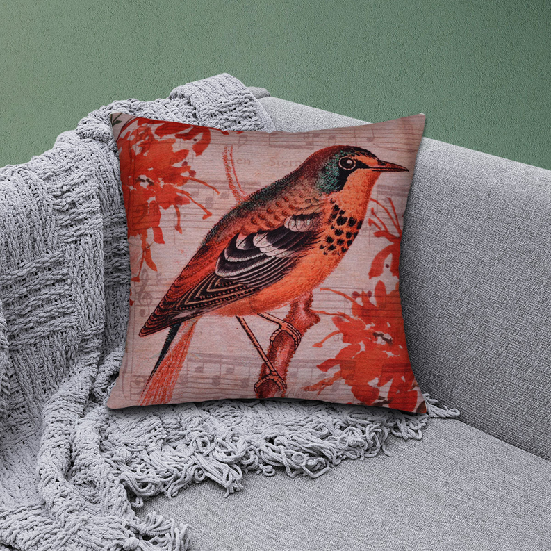 Bird-pattern pillow cover on gray sofa with red orange bird design