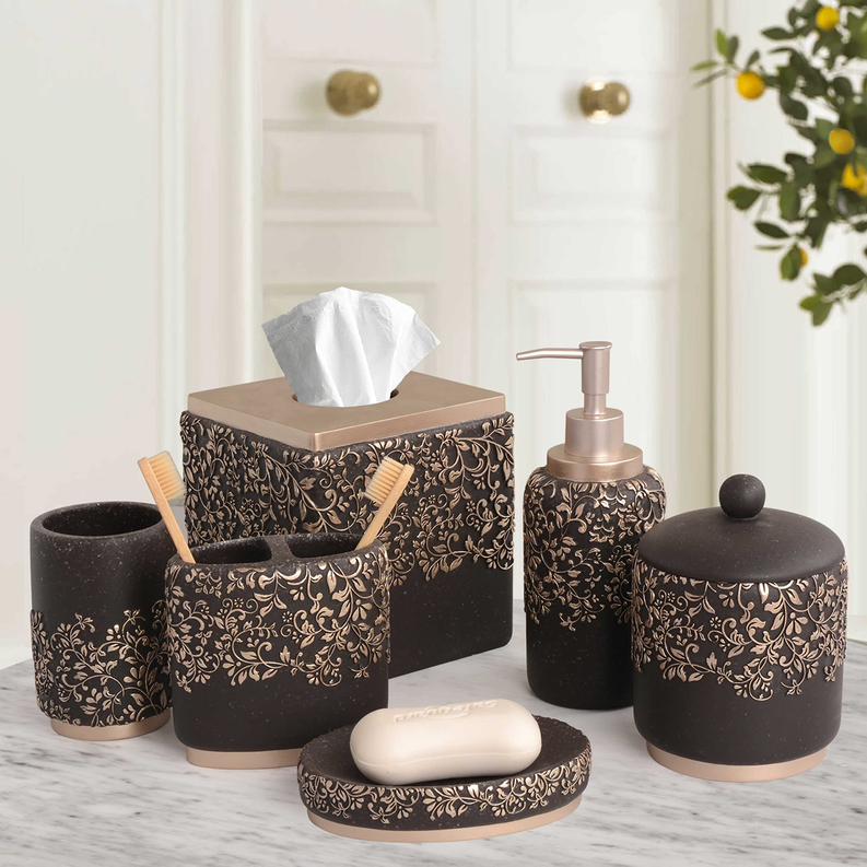 Black ceramic bathroom accessory set with gold floral tissue box, dispenser, and soap dish
