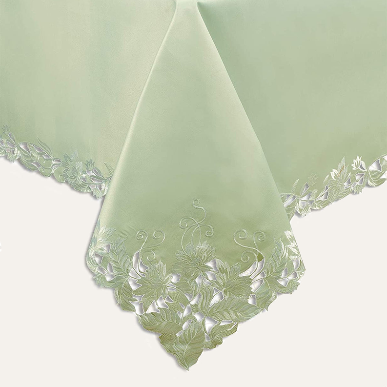 Light green embroidered table cover corner with floral vine lace border