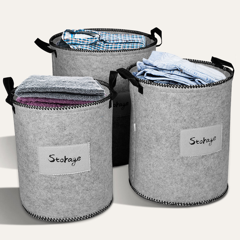 Set of gray felt storage bins with black handles and “Storage” fabric labels, open tops.