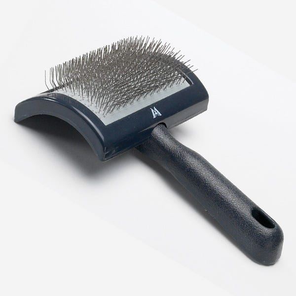 Curved slicker brush with dark blue cushion base and metal bristles, textured handle