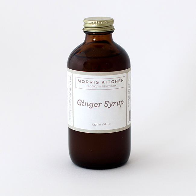 Amber-brown ginger syrup bottle with gold cap, front label facing up