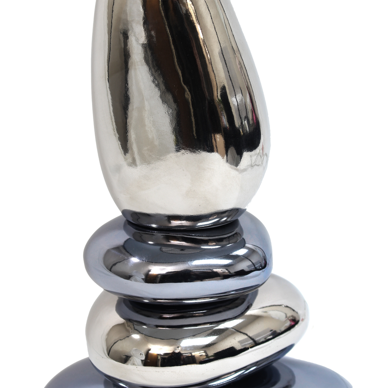 Close-up of chrome stacked table lamp base with reflective finish