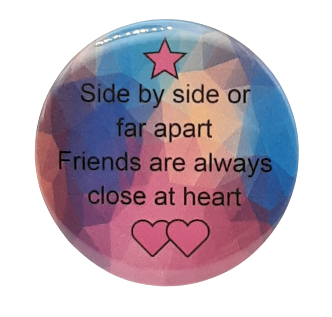 Round friendship button pin with star and hearts, featuring quote text