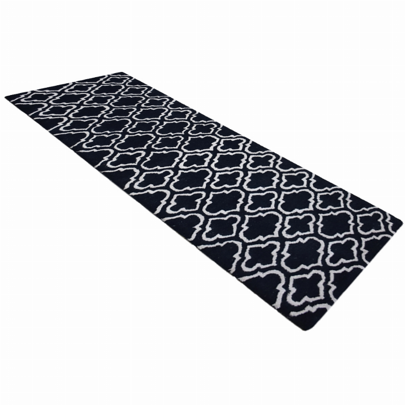 Black geometric wool runner rug with ivory quatrefoil lattice pattern.