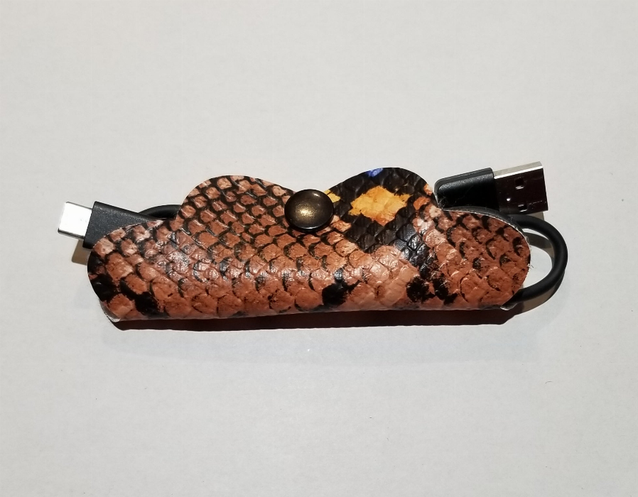Braided cord organizer pouch with metal snap, brown/black, with cable plugs