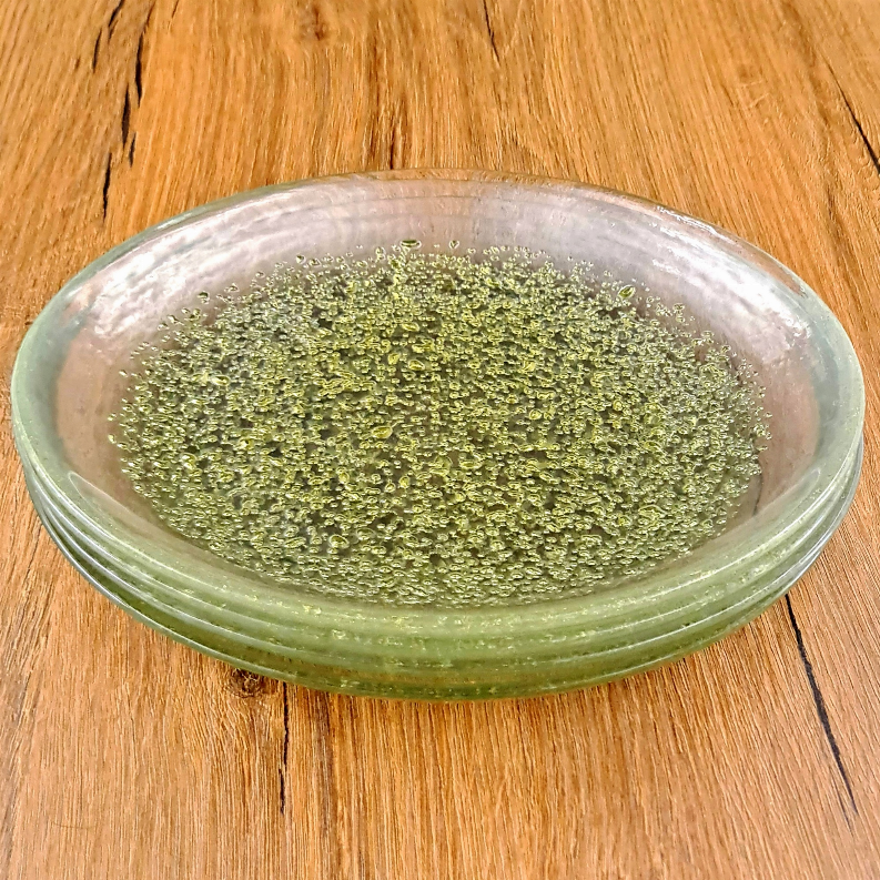 12-piece emerald green glass dinner plate stack with gold speckled surface